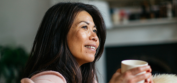 woman sitting on a couch with a mug in her hand