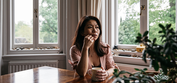 woman sitting at a table, deep in thought