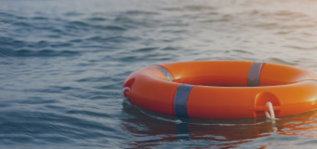 An image of a life preserver in the ocean.