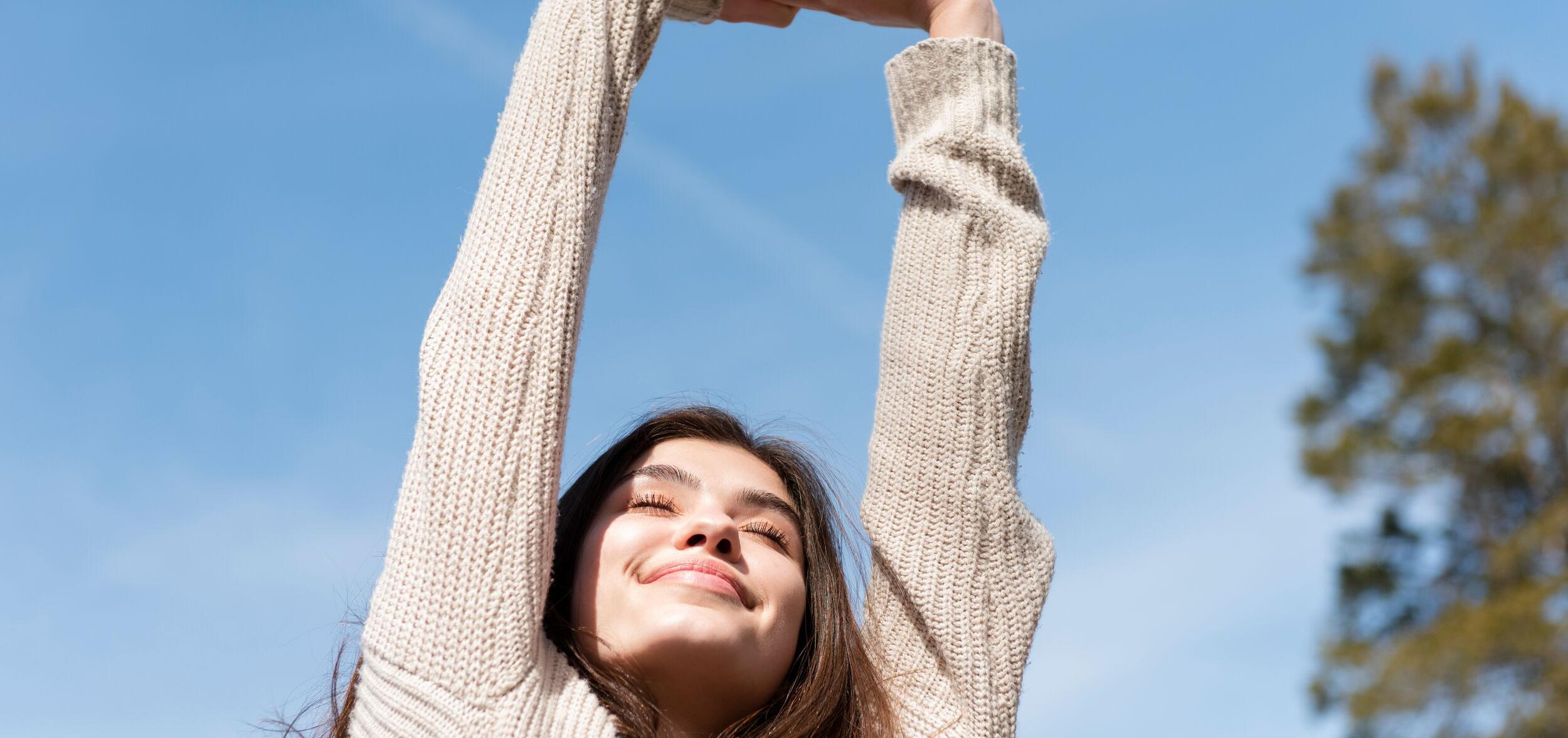 happy woman stretching her arms