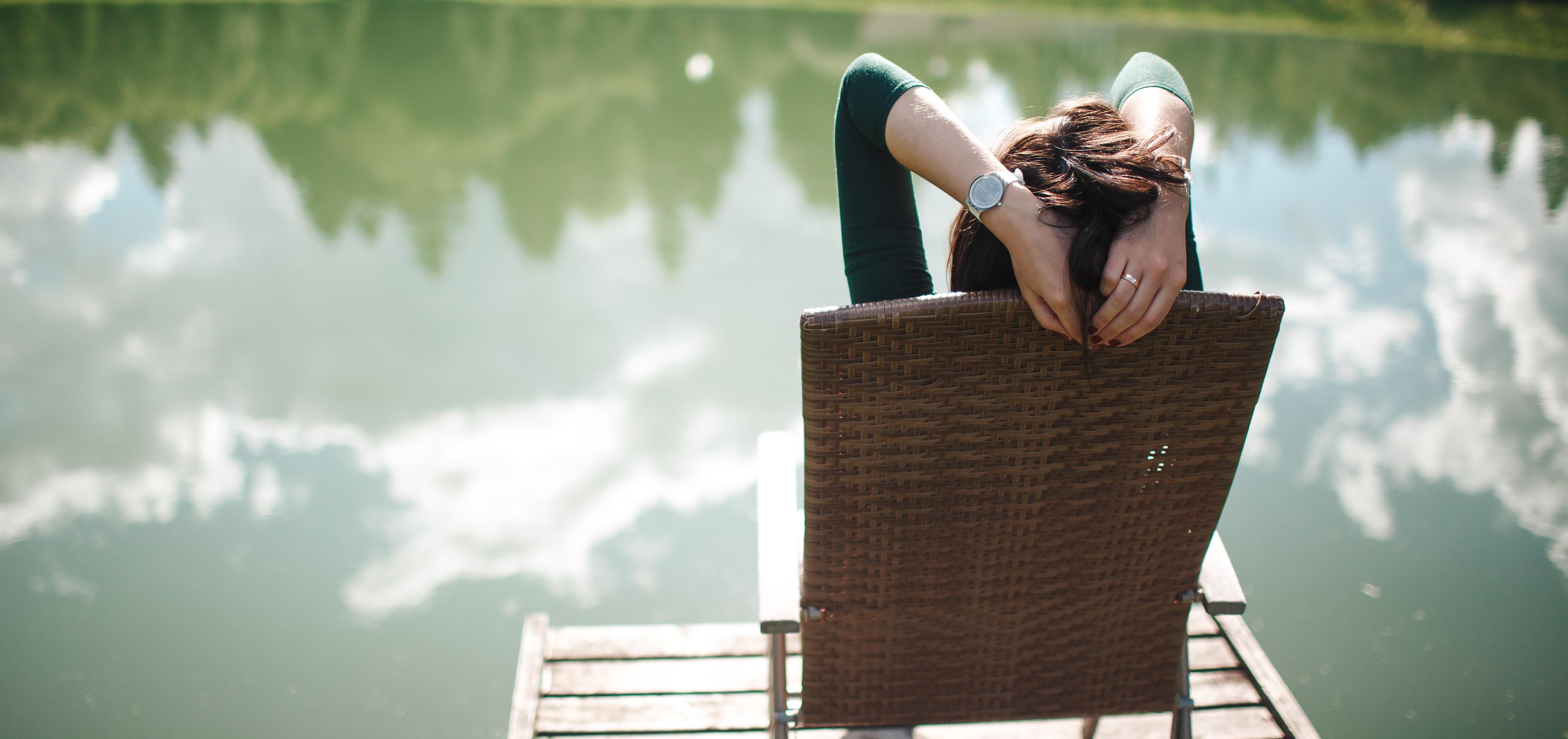 woman sitting near a lake