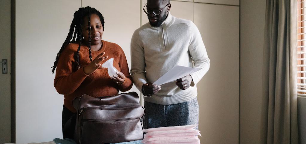 Mom and dad packing a hospital bag for delivering their baby