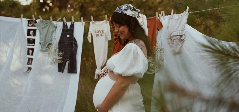 miranda posing in front of a clothesline during her pregnancy