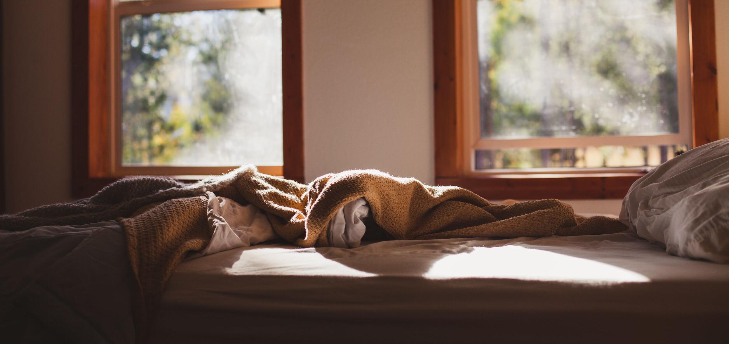 Unmade bed with tousled sheets