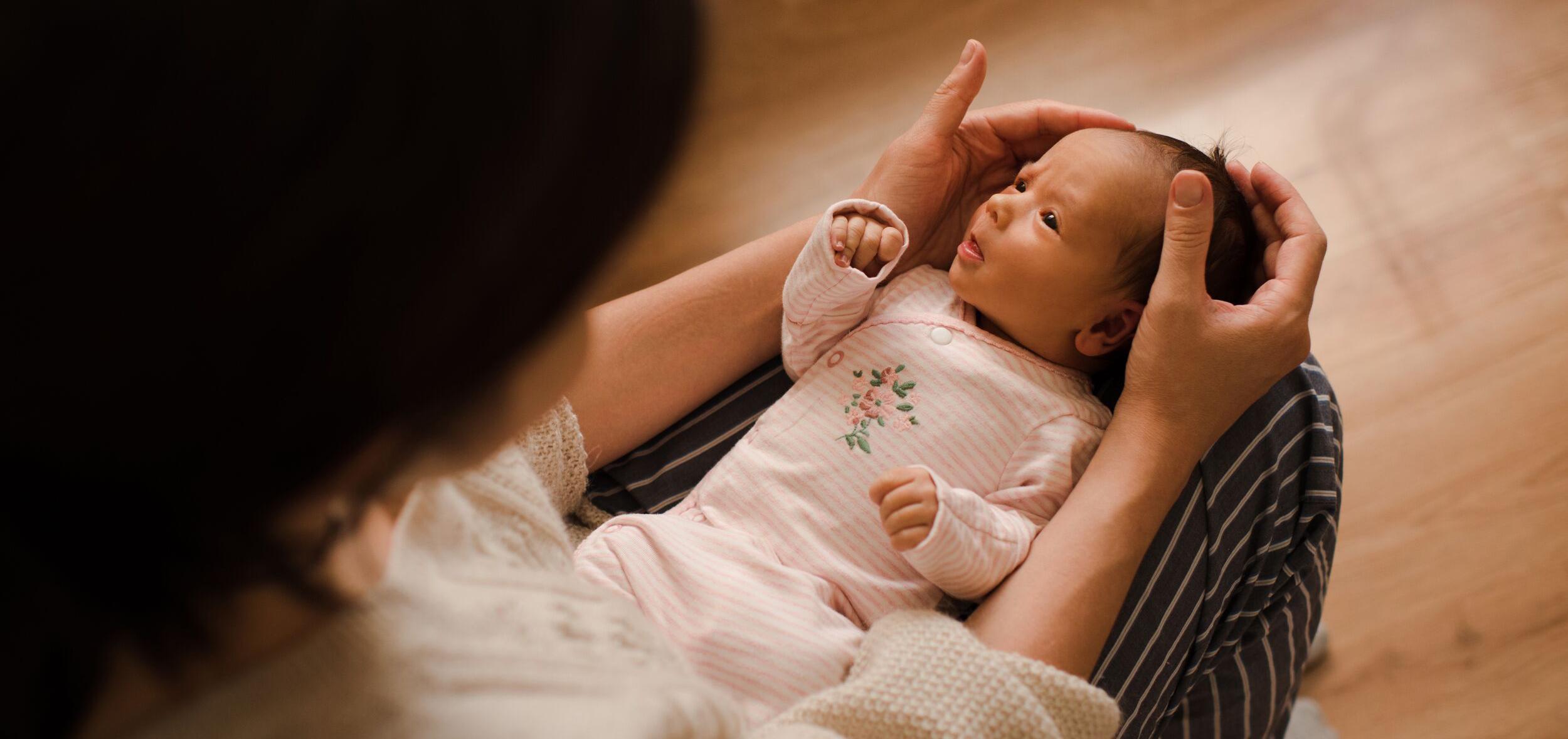 woman holding a newborn baby