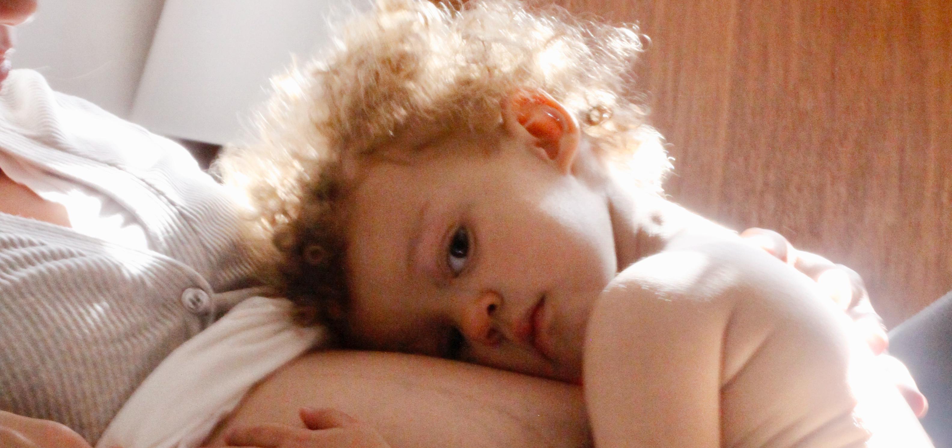 child laying on mother's pregnant belly