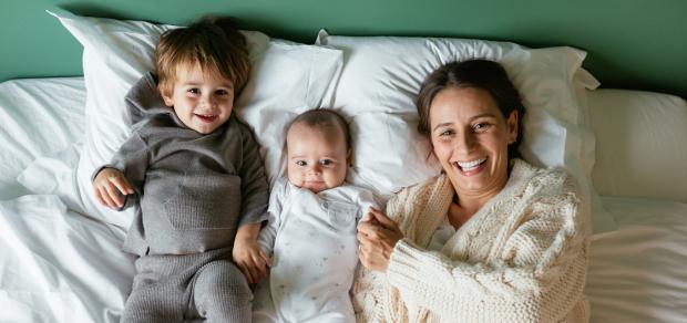 Mother in bed with her two young children