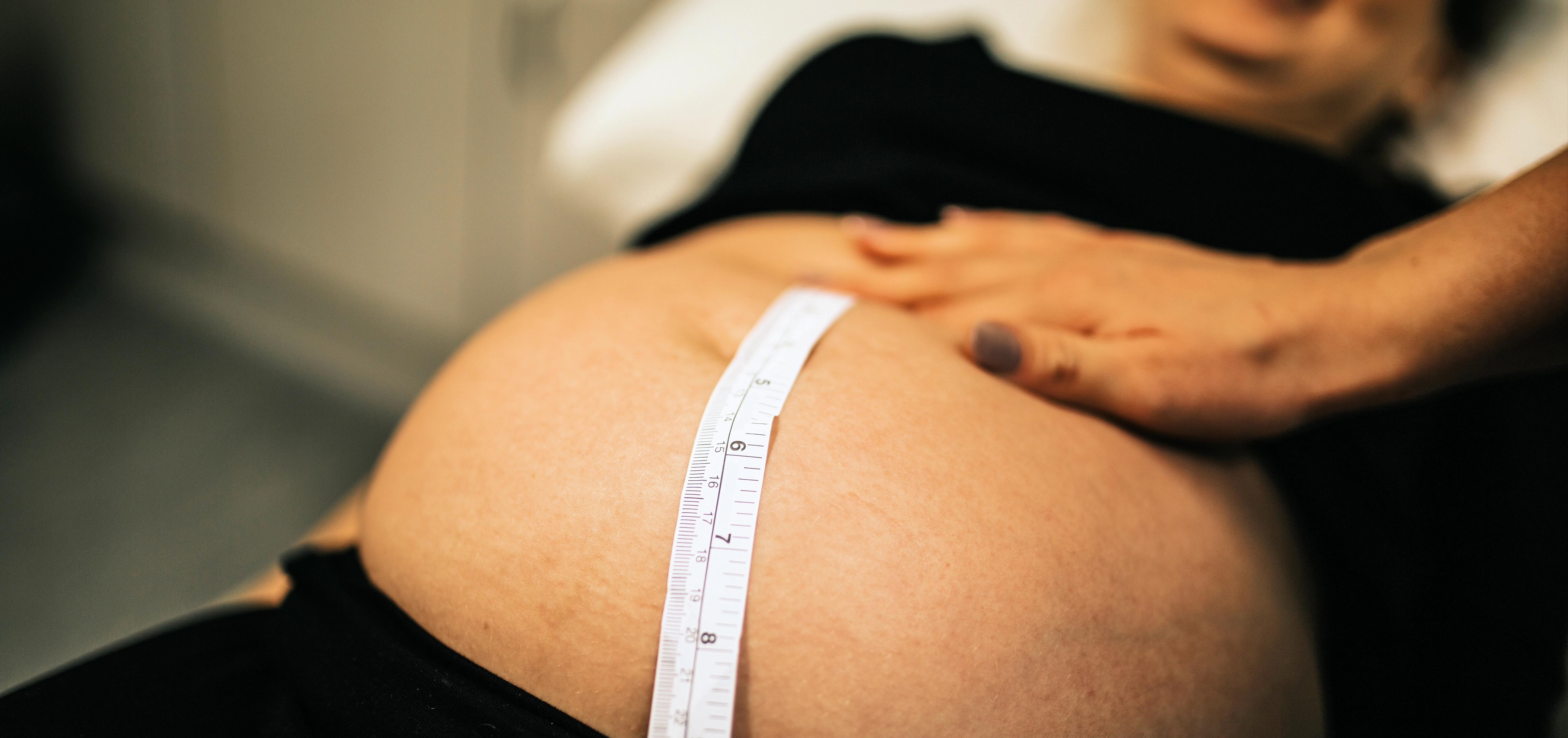 pregnant woman getting a fundal height measurement