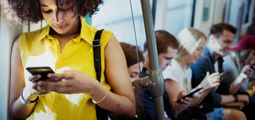 People on public transportation viewing information on their cell phones