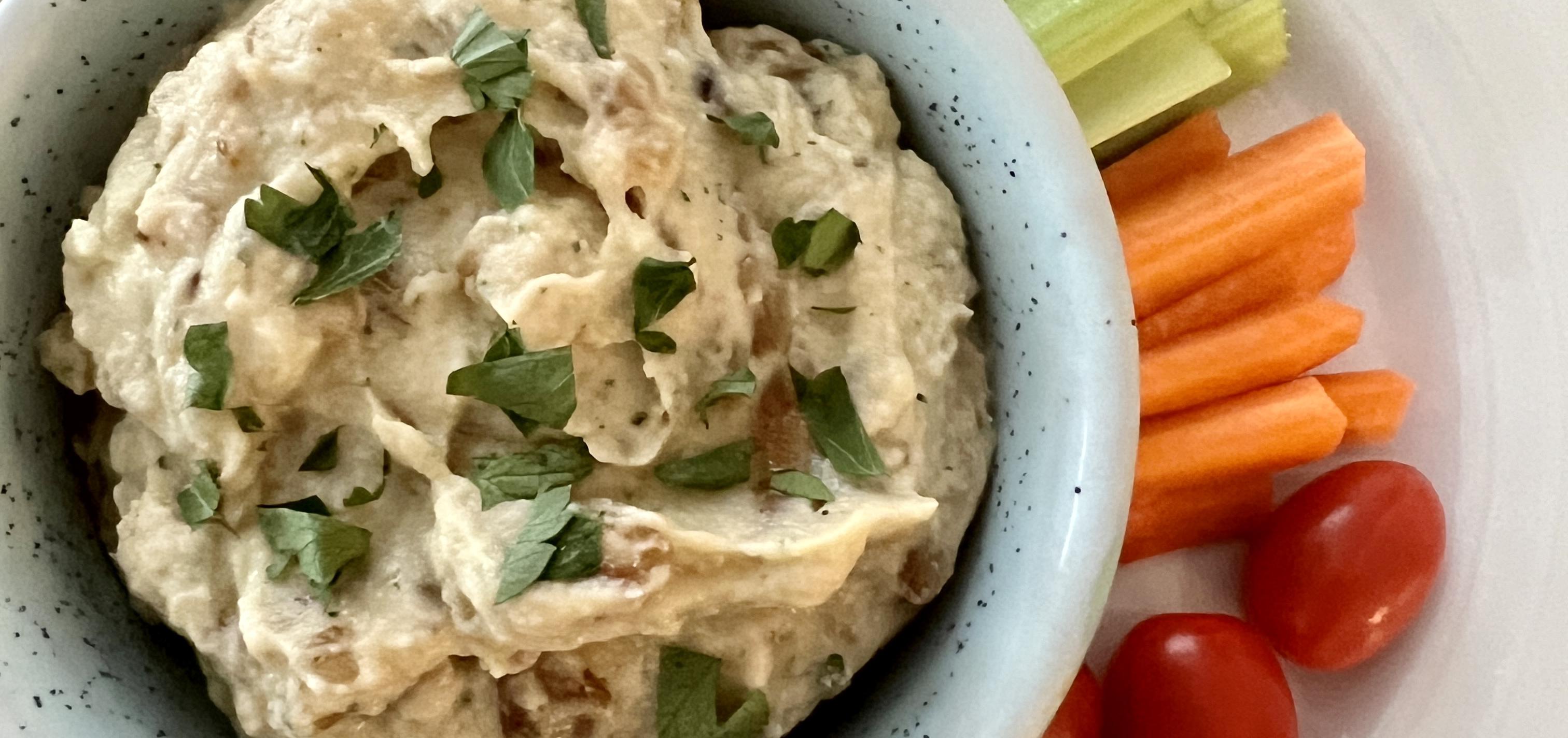 Anti-inflammatory caramelized onion dip served with cherry tomatoes and carrot and celery sticks