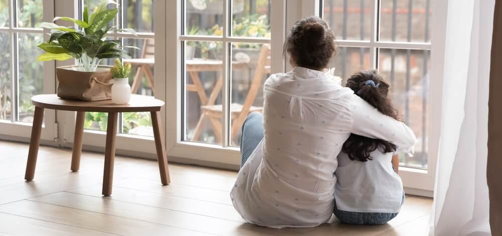 Mother and daughter looking out the window