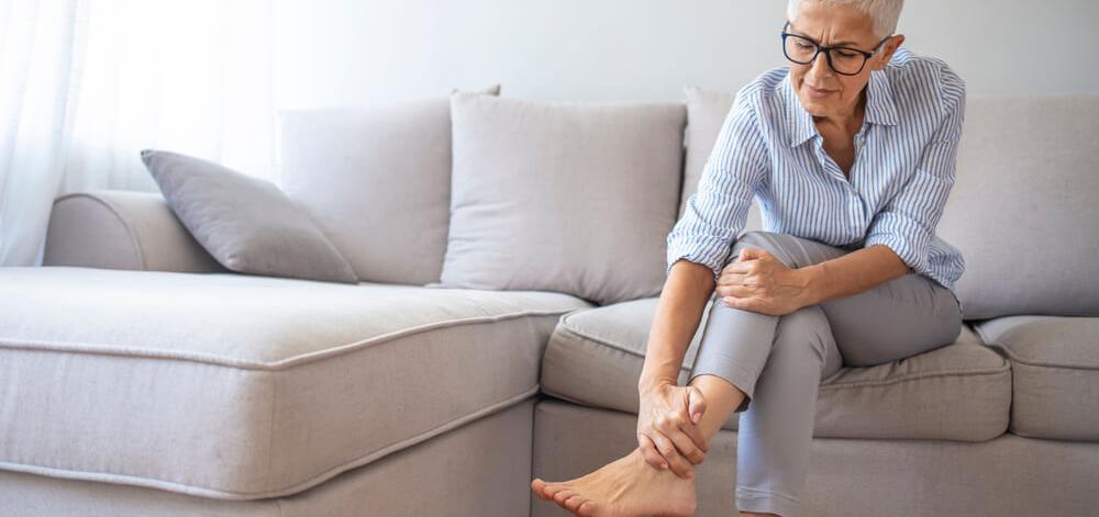 Woman with diabetes experiencing diabetic neuropathy in her feet and legs