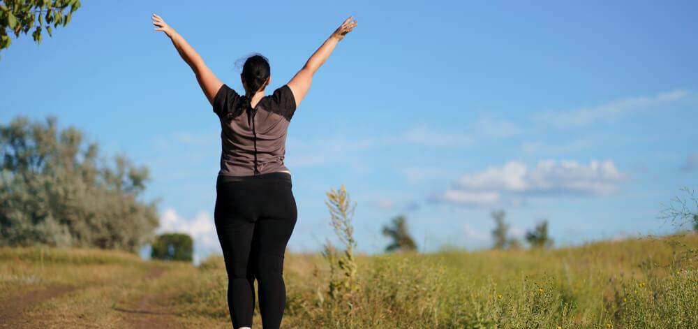 woman with her arms up celebrating success
