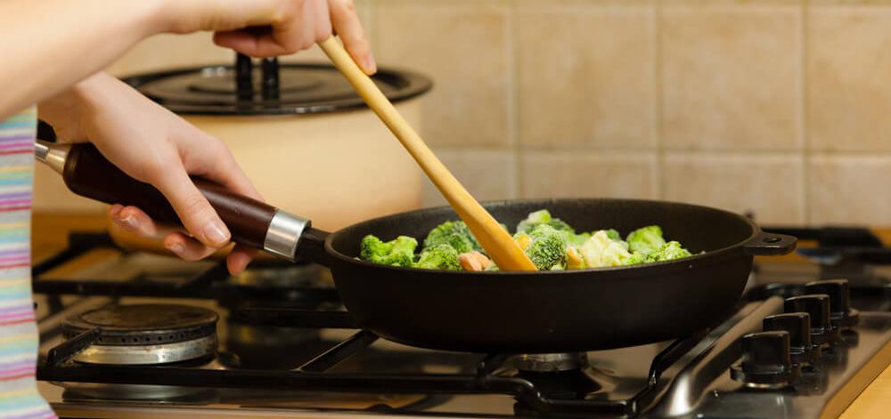 person cooking a healthy stir fry at home