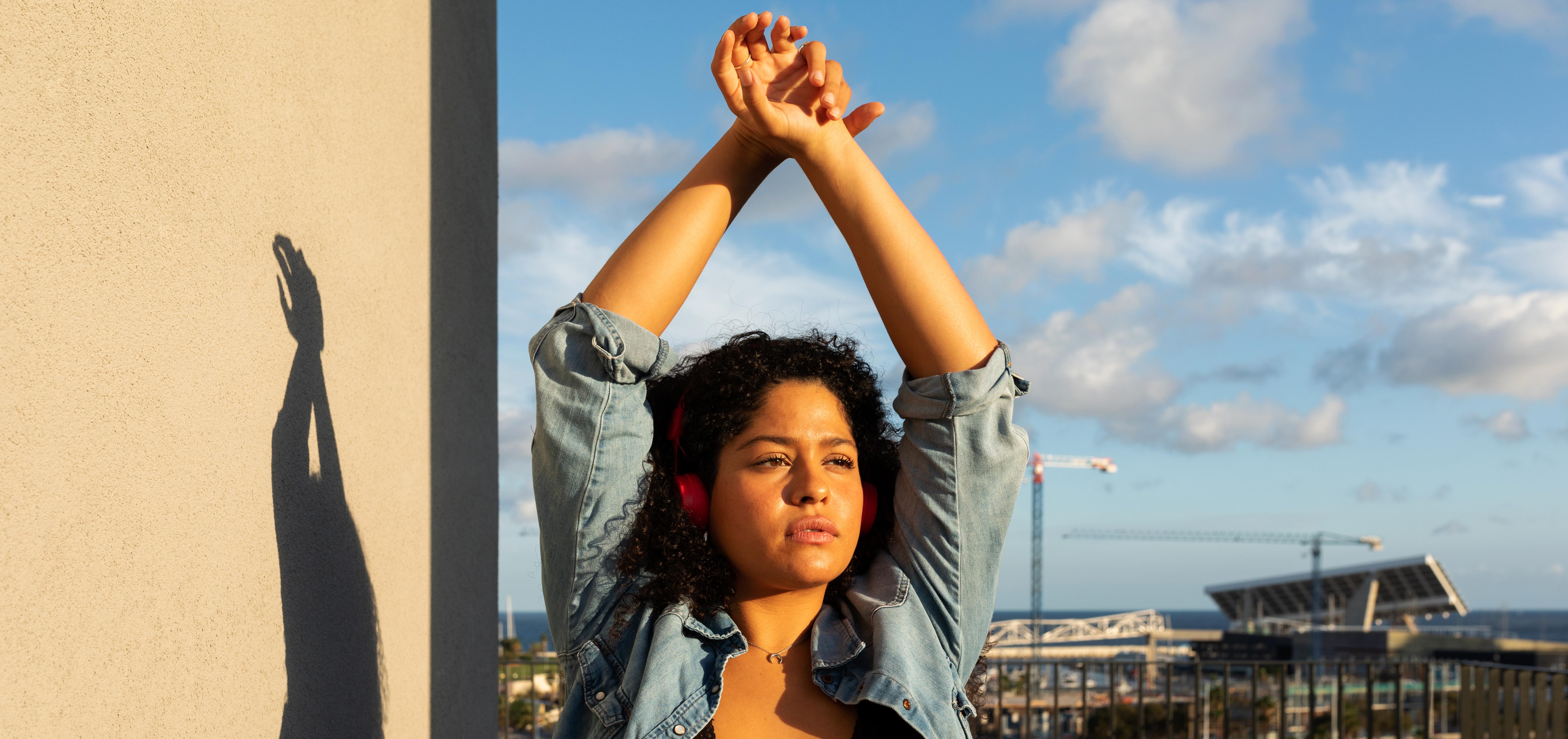 woman with raised hands outside