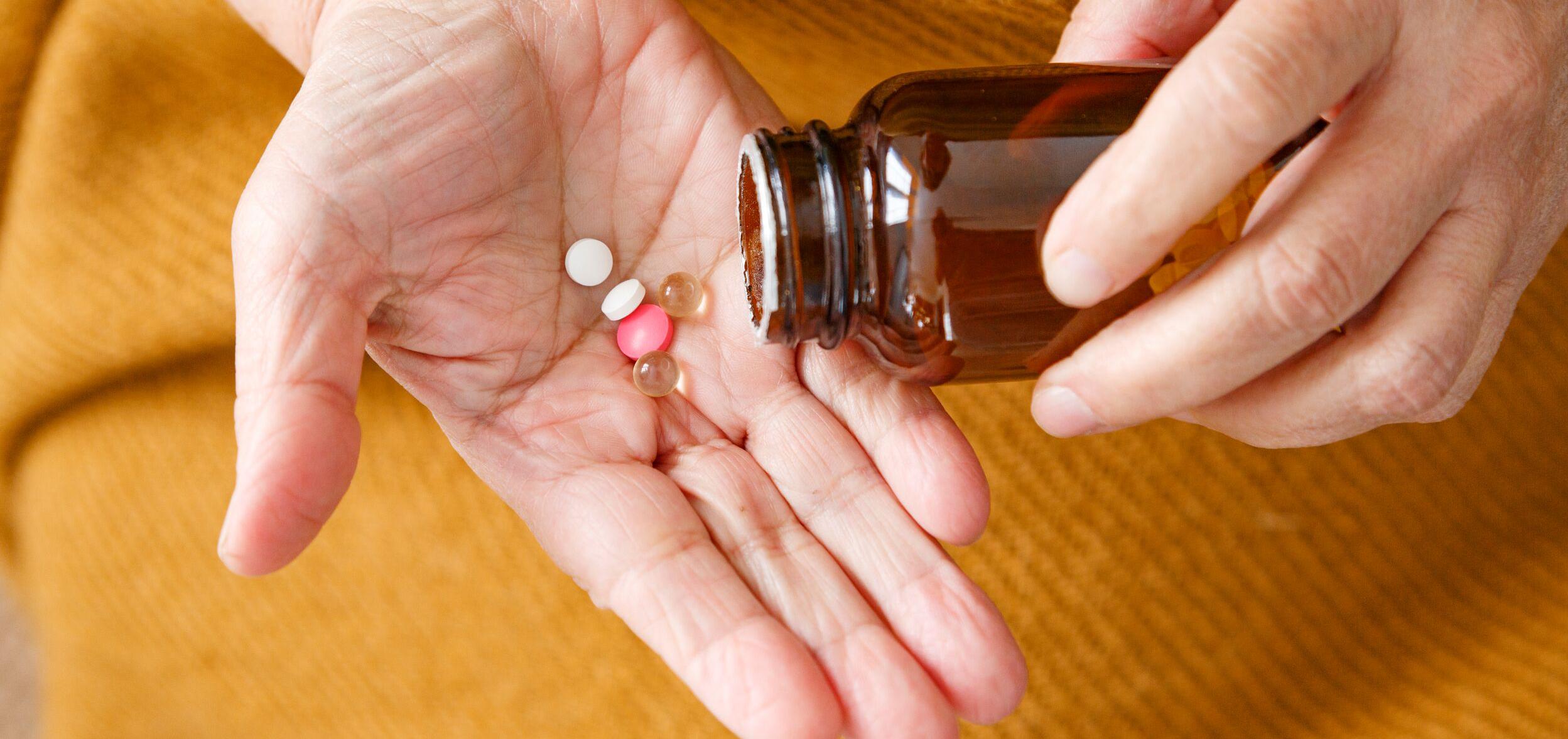 a hand with tablets in it