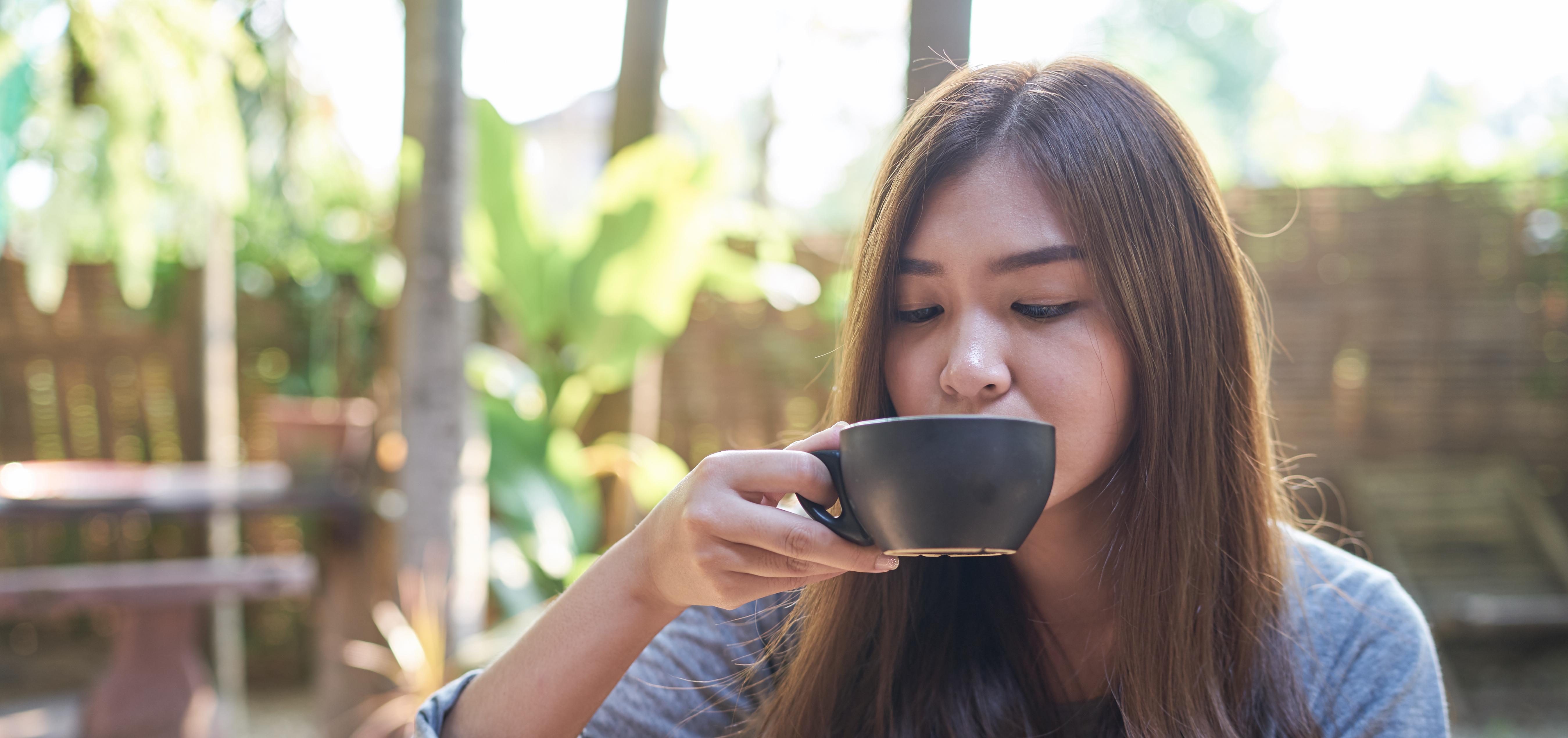 Woman drinking ginger tea as a morning sickness remedy