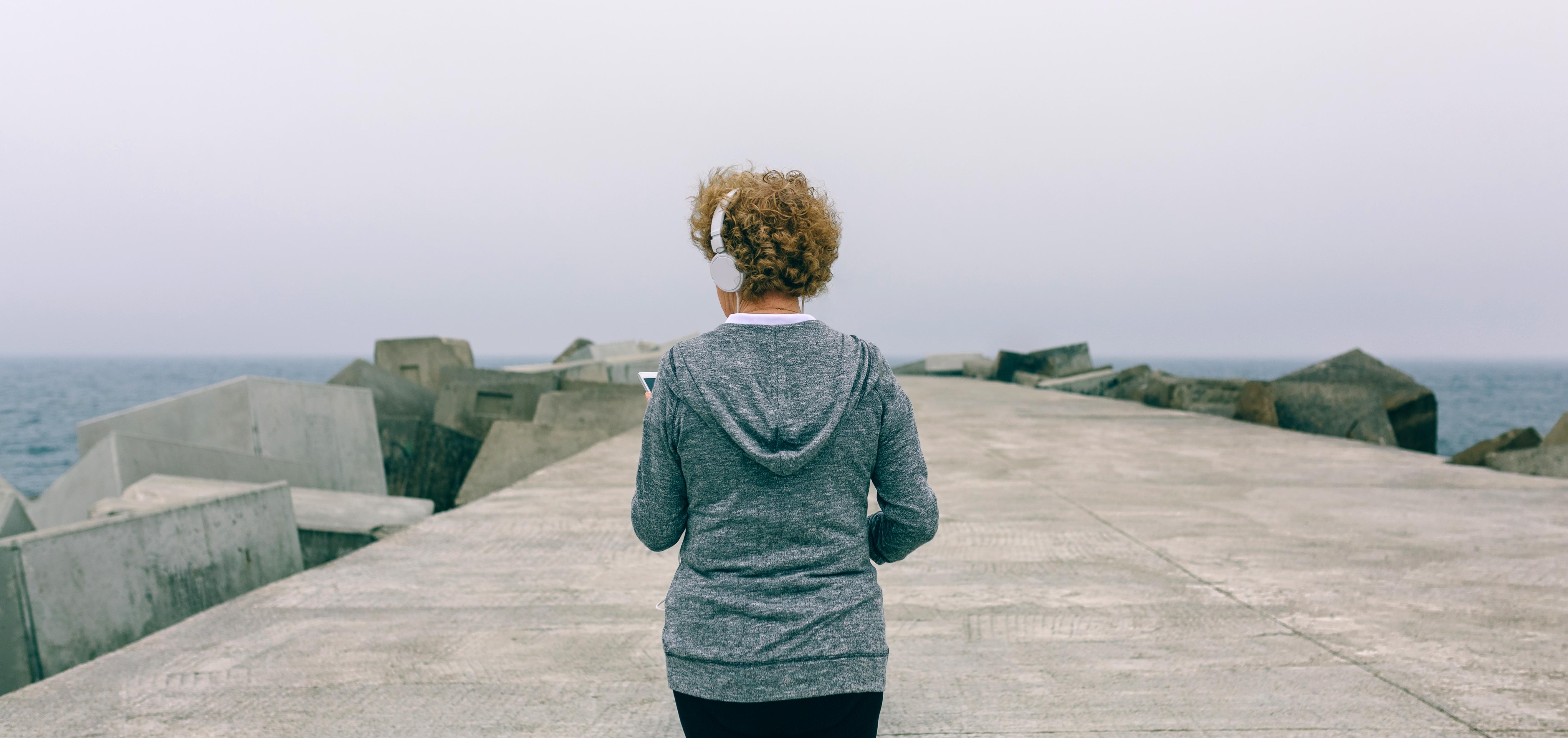 woman with headphones walking