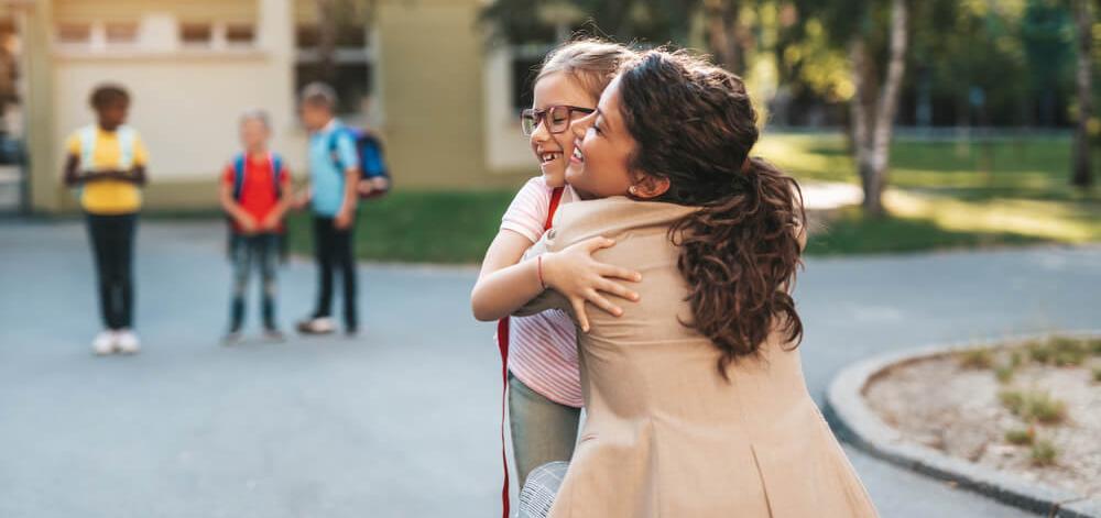 Mother hugging child with type 1 diabetes before going to school