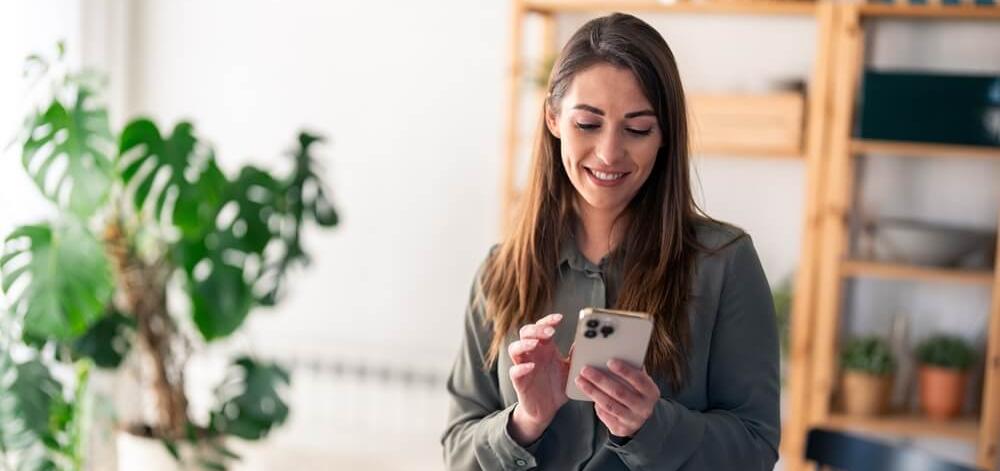 woman at home looking at health information on her phone