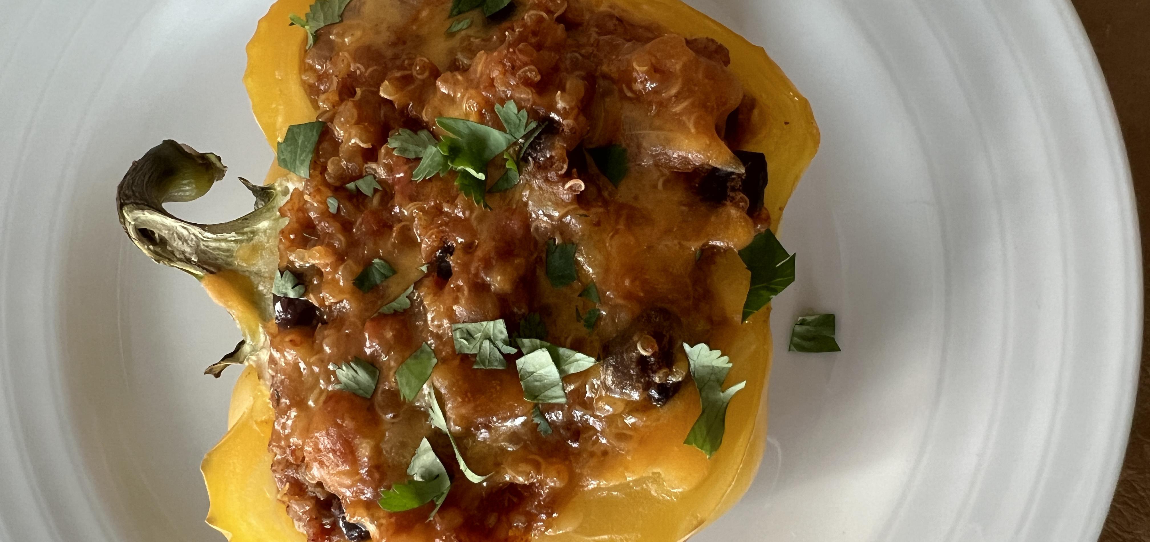 Southwest-inspired vegetarian stuffed pepper half, on a white plate