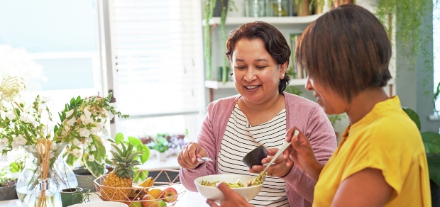 two women having a salad in the kitchen