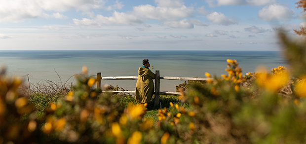 woman looking out over the water, thinking about her treatment options