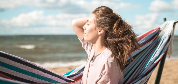 woman outside next to a hammock