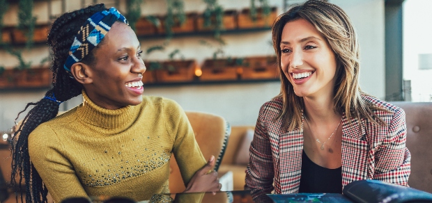 two women spending time together in a cafe